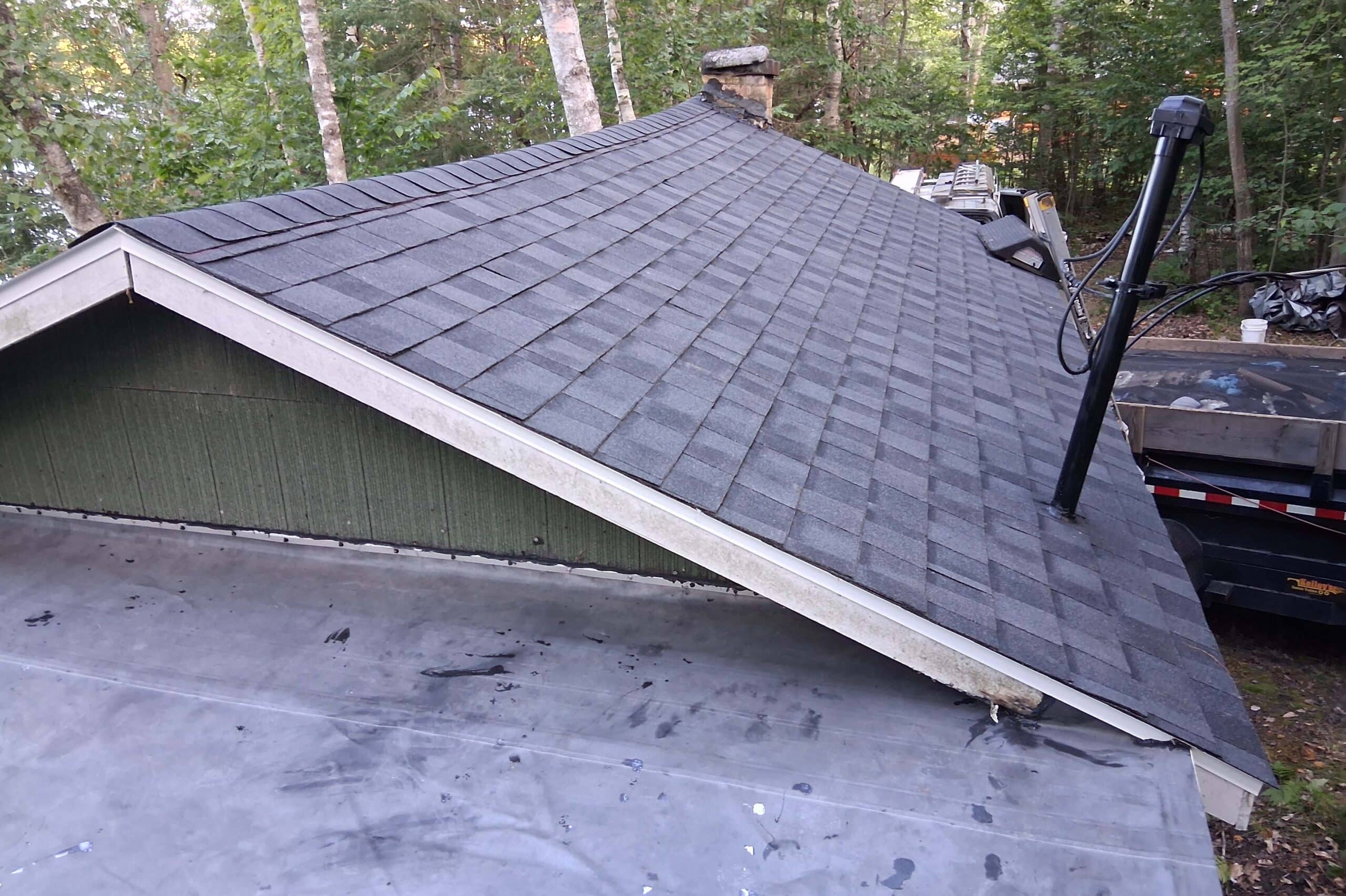 roofing contractor northport mi — completed dark gray shingle roof